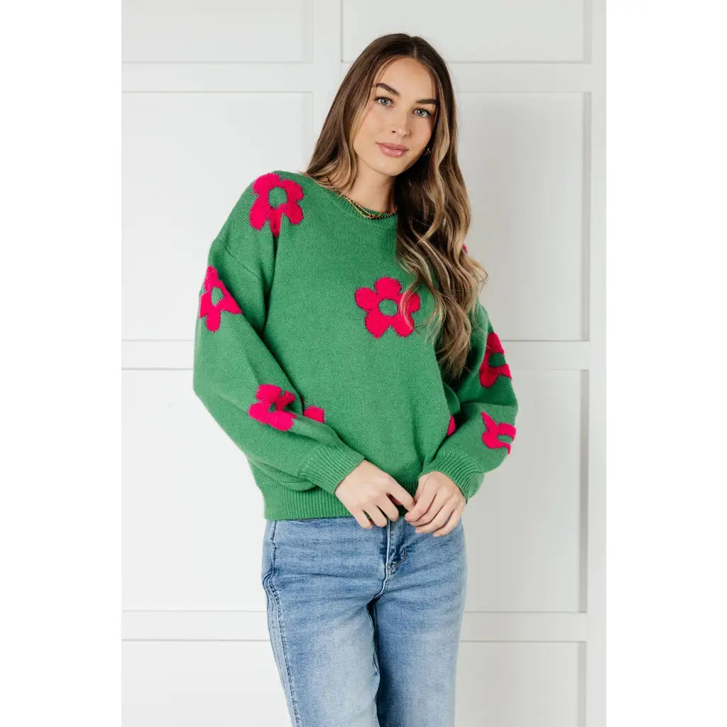 Stay cozy in The Bloom Sweater! A soft ribbed knit pullover with tufted pink flowers balloon sleeves and a relaxed fit.