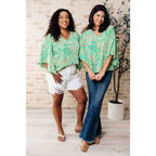 Get ready to embrace the future with our The Future’s Wide Open V-Neck Top! Made soft woven fabric this playful