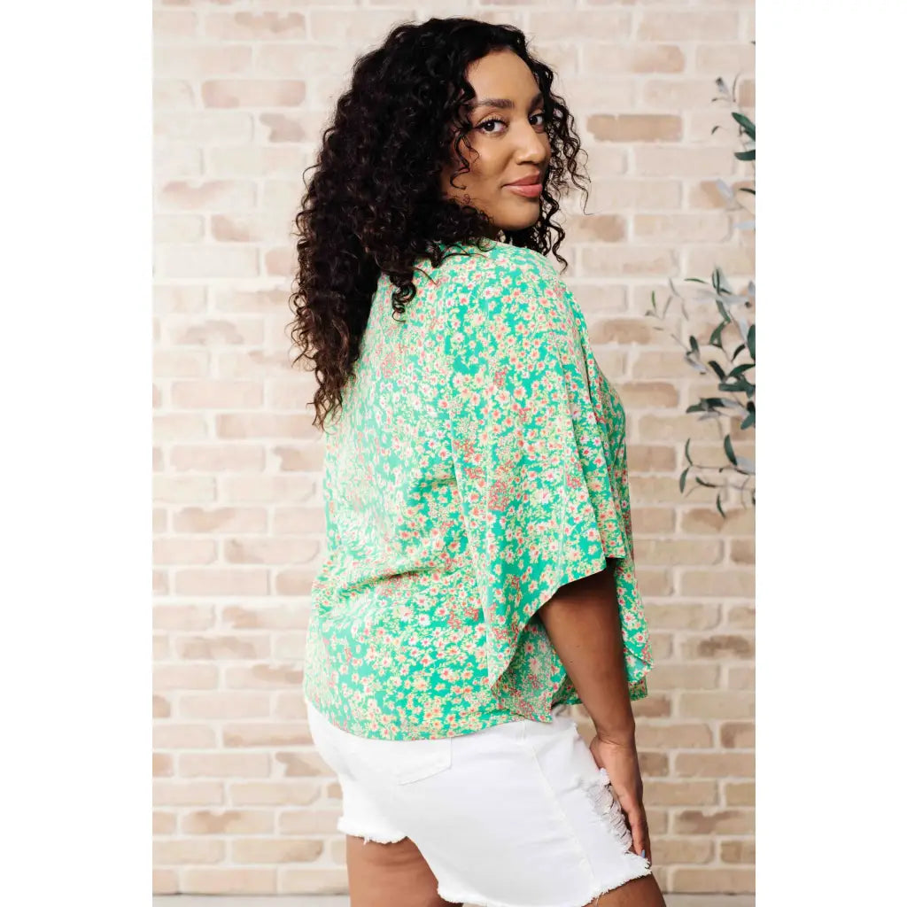 Get ready to embrace the future with our The Future’s Wide Open V-Neck Top! Made soft woven fabric this playful