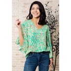 Get ready to embrace the future with our The Future’s Wide Open V-Neck Top! Made soft woven fabric this playful