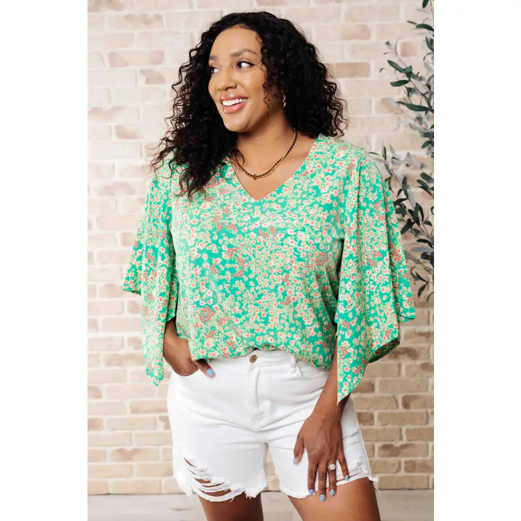 Get ready to embrace the future with our The Future’s Wide Open V-Neck Top! Made soft woven fabric this playful