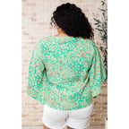 Get ready to embrace the future with our The Future’s Wide Open V-Neck Top! Made soft woven fabric this playful