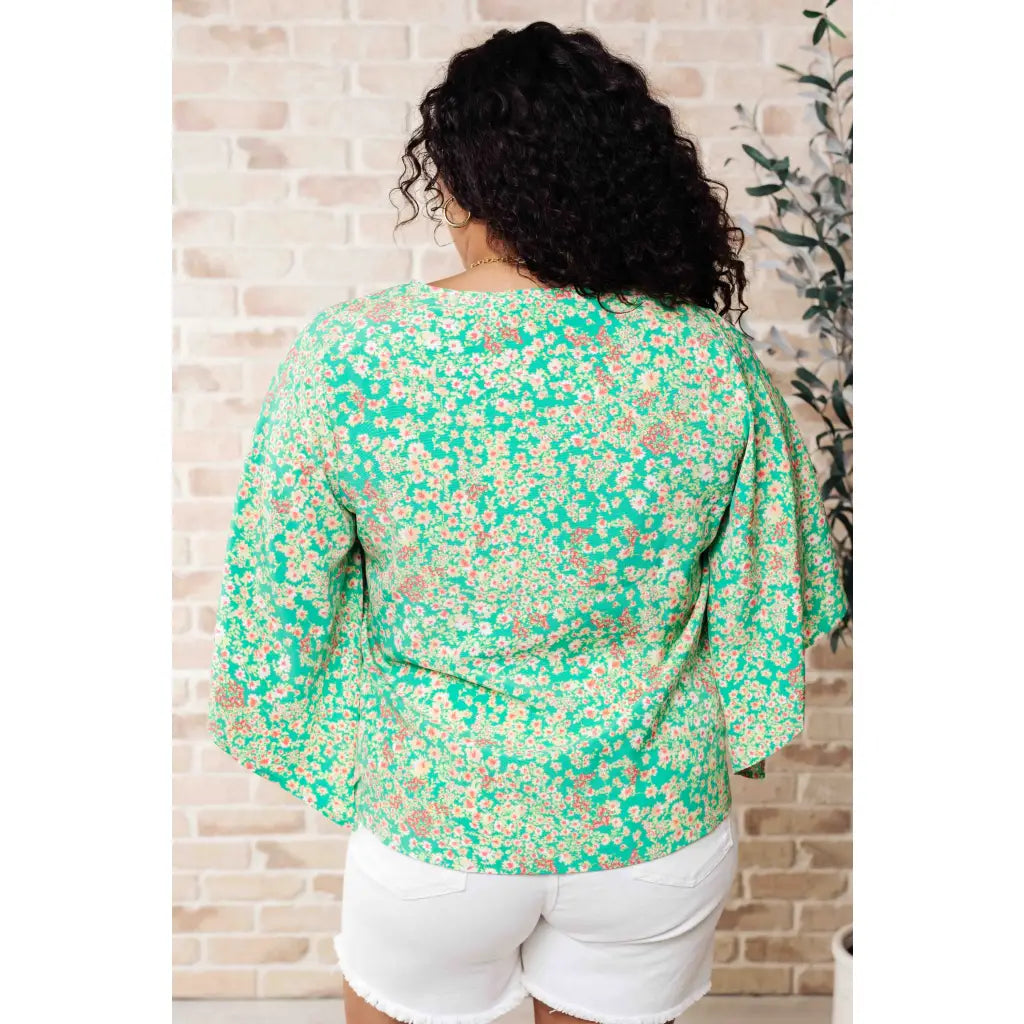 Get ready to embrace the future with our The Future’s Wide Open V-Neck Top! Made soft woven fabric this playful