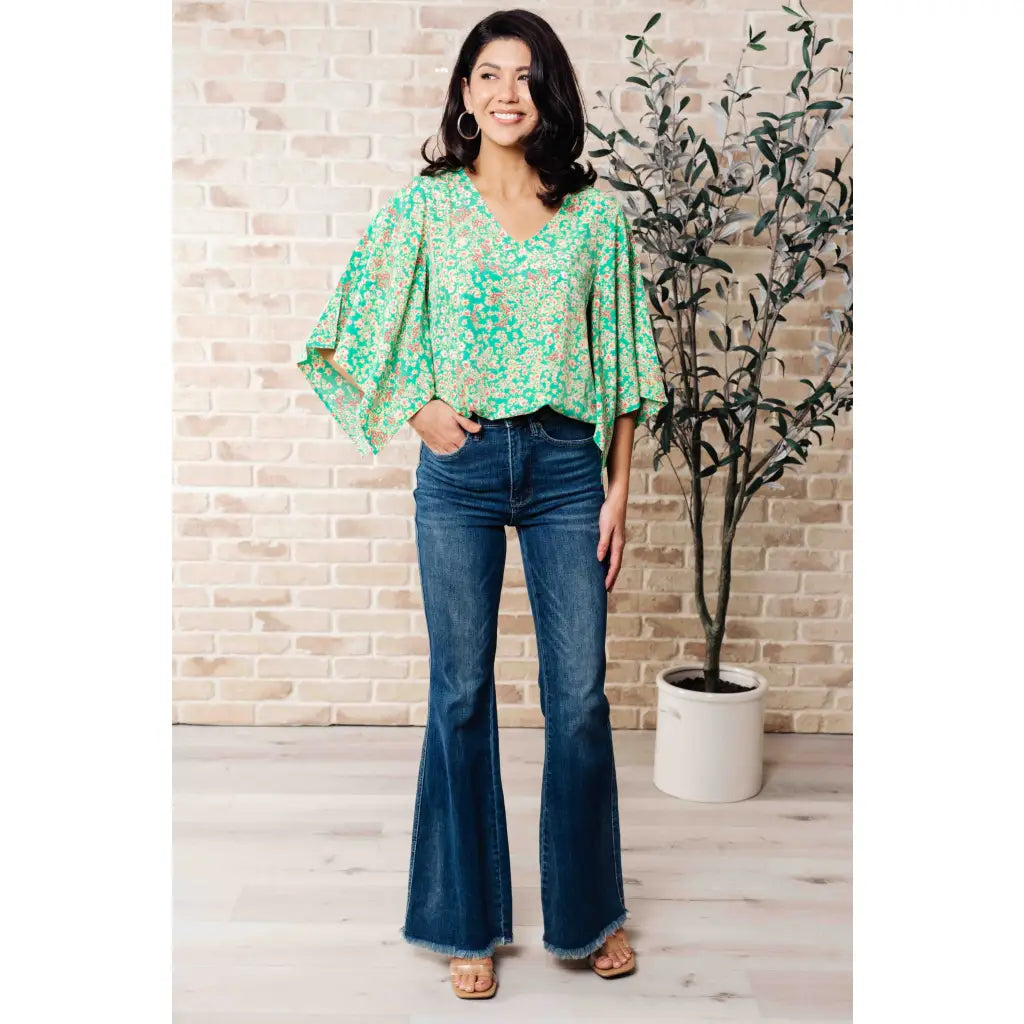 Get ready to embrace the future with our The Future’s Wide Open V-Neck Top! Made soft woven fabric this playful