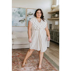 Look stunning in the Twisted and Tailored Vertical Striped Dress! Featuring a knotted front deep v-neck faux wrap. Plus