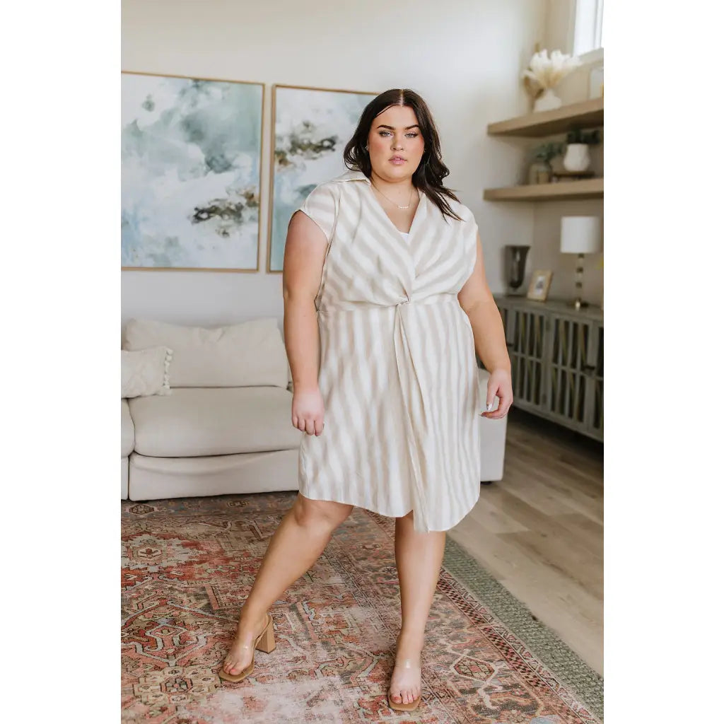 Look stunning in the Twisted and Tailored Vertical Striped Dress! Featuring a knotted front deep v-neck faux wrap. Plus