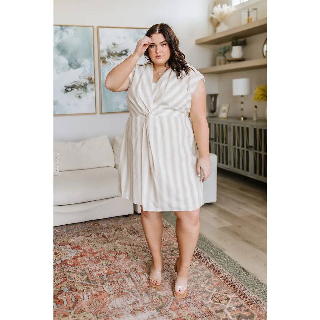 Look stunning in the Twisted and Tailored Vertical Striped Dress! Featuring a knotted front deep v-neck faux wrap. Plus
