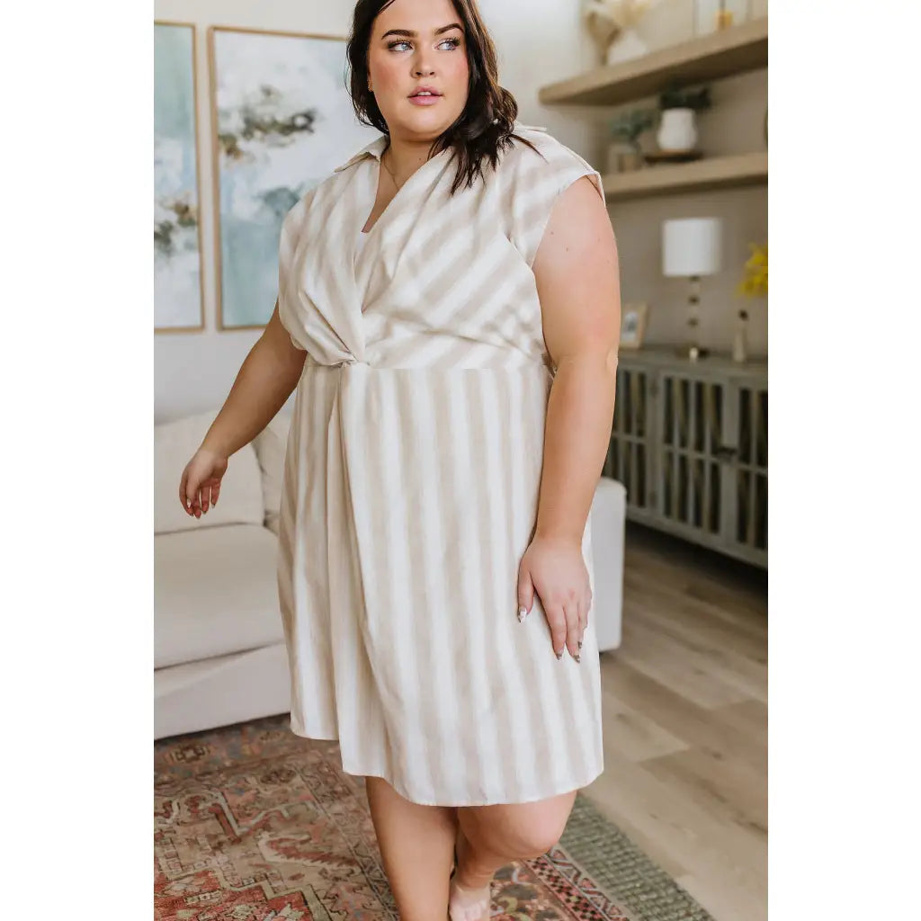 Look stunning in the Twisted and Tailored Vertical Striped Dress! Featuring a knotted front deep v-neck faux wrap. Plus