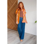 Make a statement in the Two Sides to Story Blouse! Half solid orange half paisley and floral mix print short sleeve top