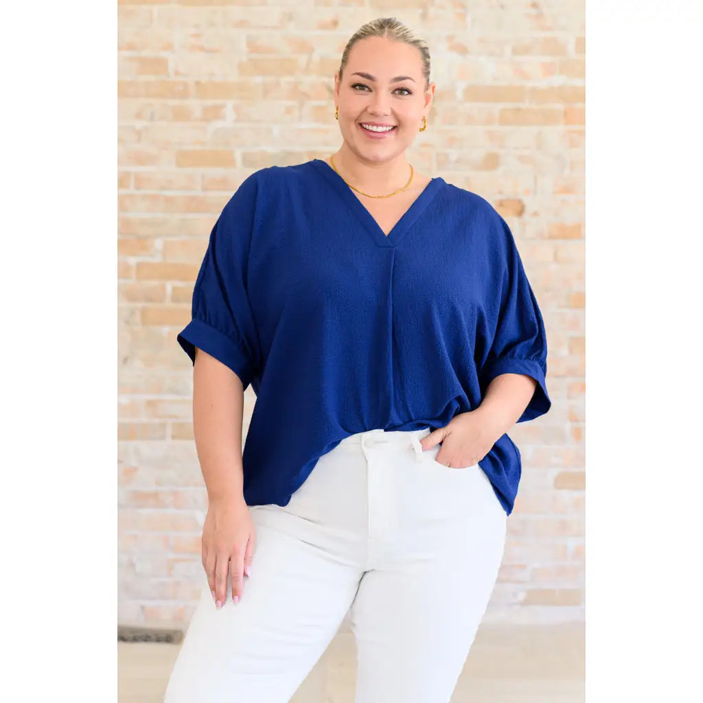 Our Up For Anything V Neck Blouse in Navy is a perfect staple piece for any closet! The crinkle woven fabric adds