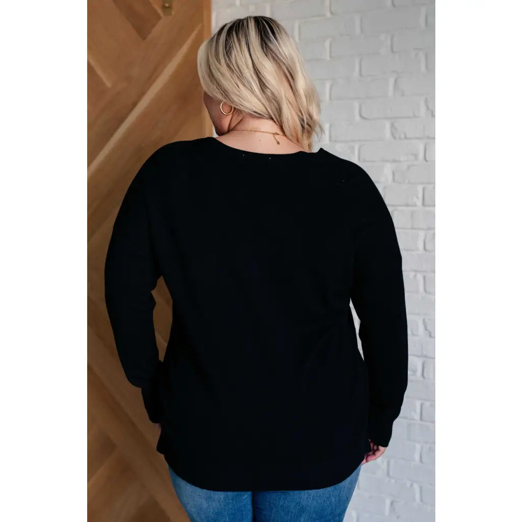 Our V-Neck Front Seam Sweater in black add a stylish touch to your closet! The dropped shoulder and relaxed fit