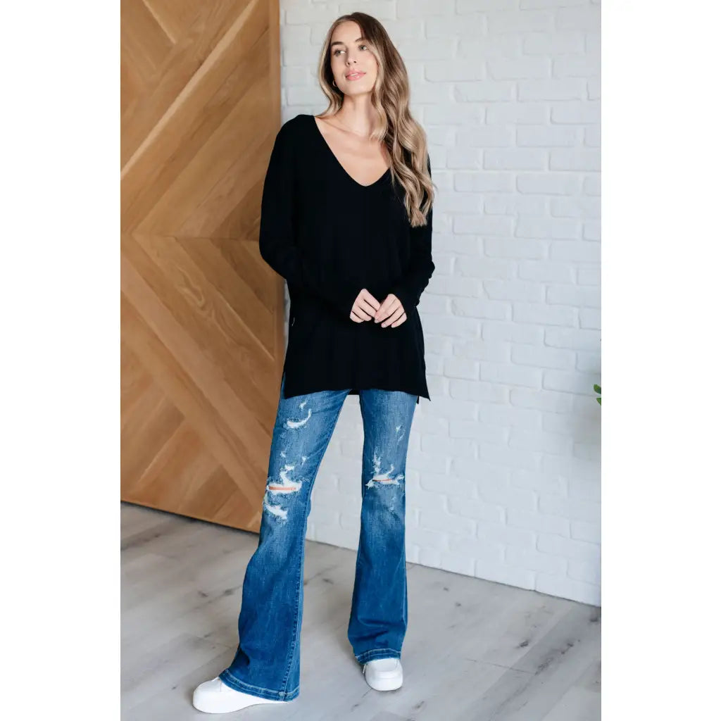 Our V-Neck Front Seam Sweater in black add a stylish touch to your closet! The dropped shoulder and relaxed fit