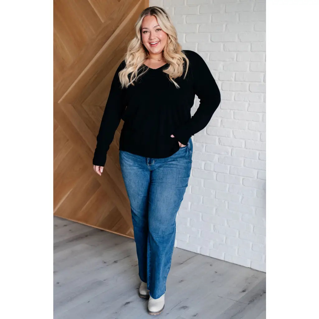 Our V-Neck Front Seam Sweater in black add a stylish touch to your closet! The dropped shoulder and relaxed fit