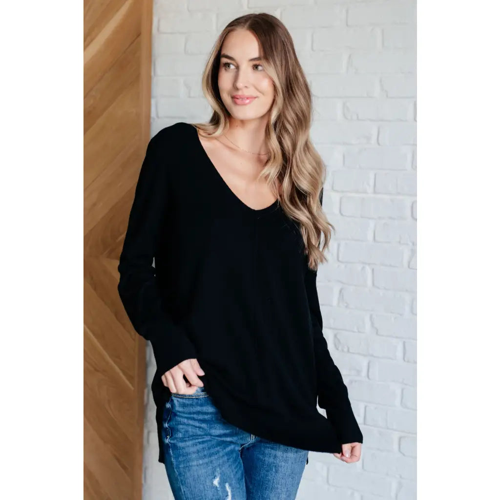 Our V-Neck Front Seam Sweater in black add a stylish touch to your closet! The dropped shoulder and relaxed fit