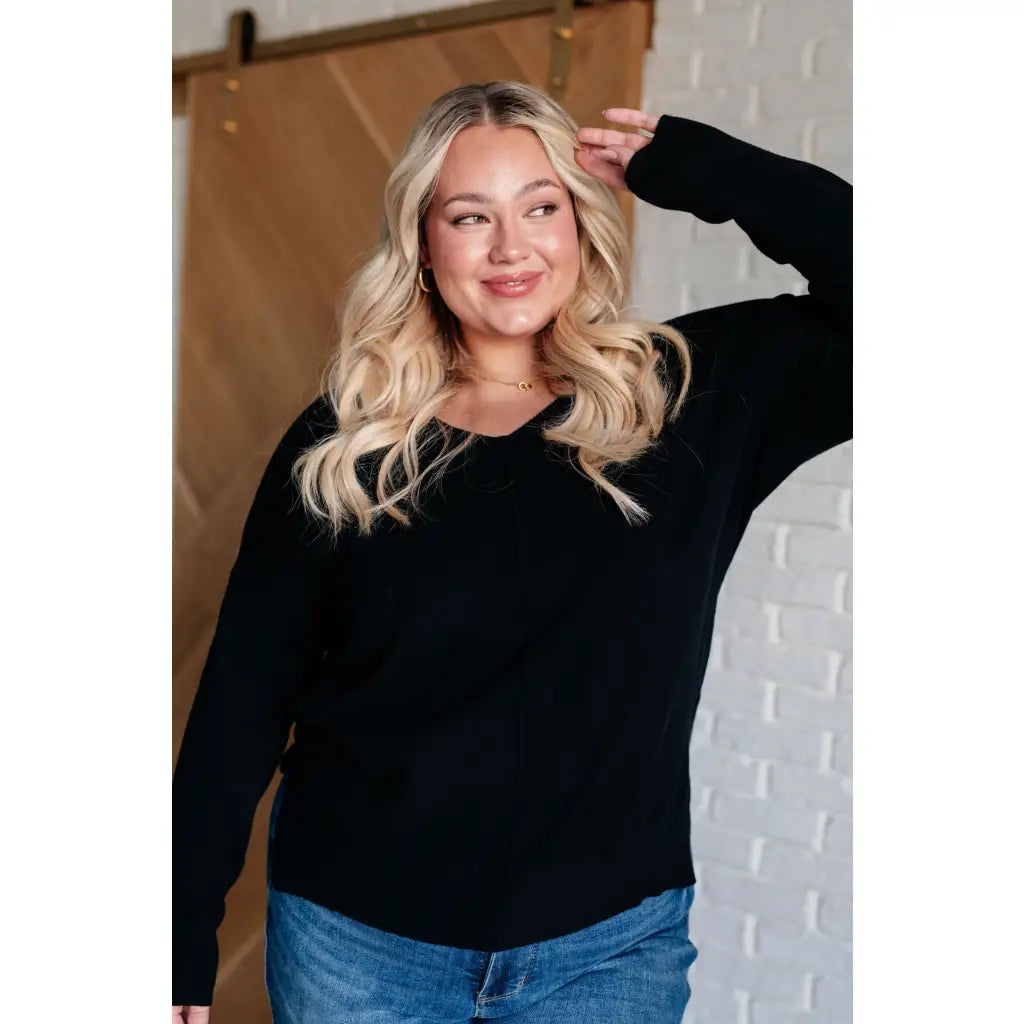 Our V-Neck Front Seam Sweater in black add a stylish touch to your closet! The dropped shoulder and relaxed fit