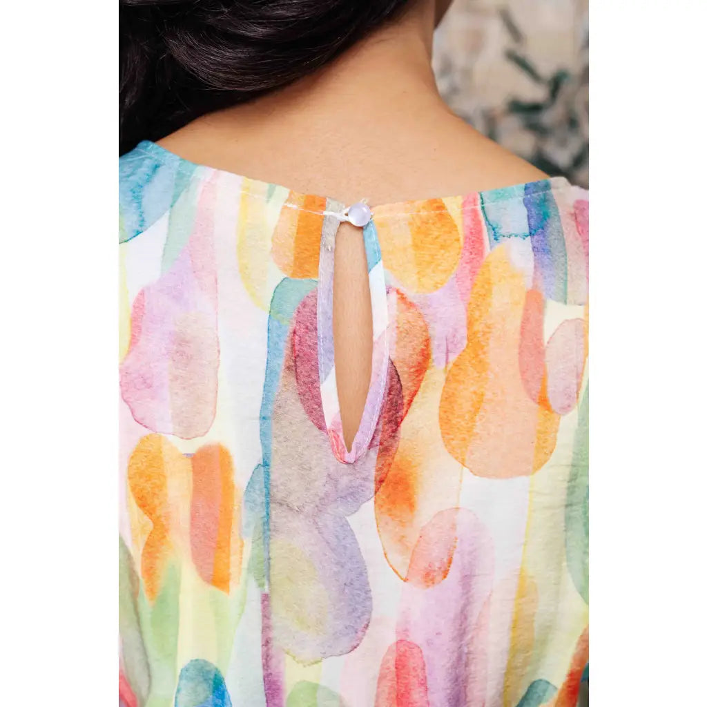 Midi dress with abstract watercolor print sleeves and flattering fit. Available in standard plus size. Spring ready