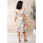 Midi dress with abstract watercolor print sleeves and flattering fit. Available in standard plus size. Spring ready