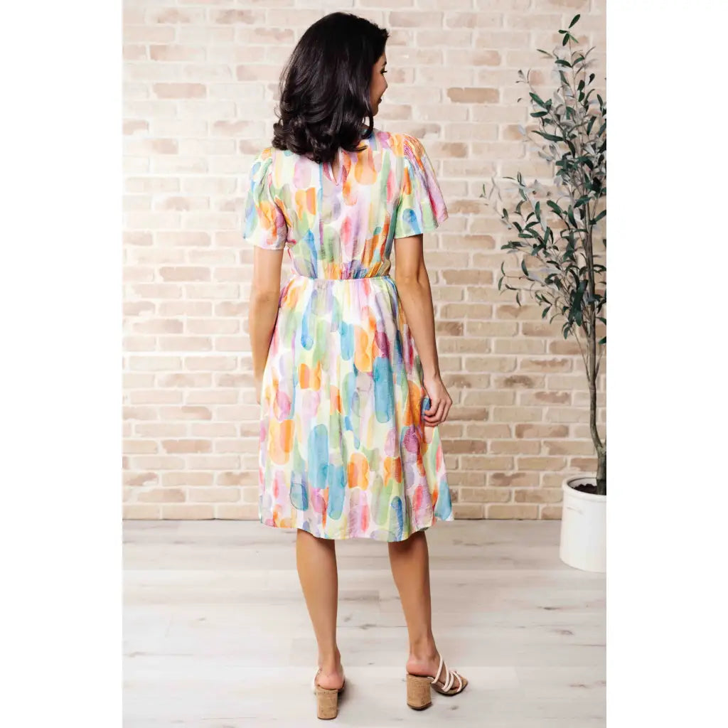 Midi dress with abstract watercolor print sleeves and flattering fit. Available in standard plus size. Spring ready