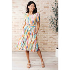 Midi dress with abstract watercolor print sleeves and flattering fit. Available in standard plus size. Spring ready