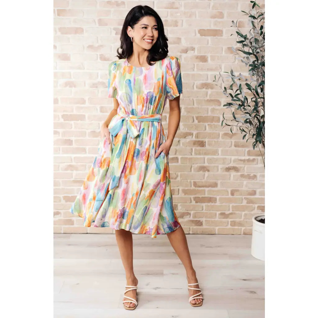 Midi dress with abstract watercolor print sleeves and flattering fit. Available in standard plus size. Spring ready