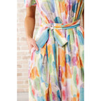 Midi dress with abstract watercolor print sleeves and flattering fit. Available in standard plus size. Spring ready