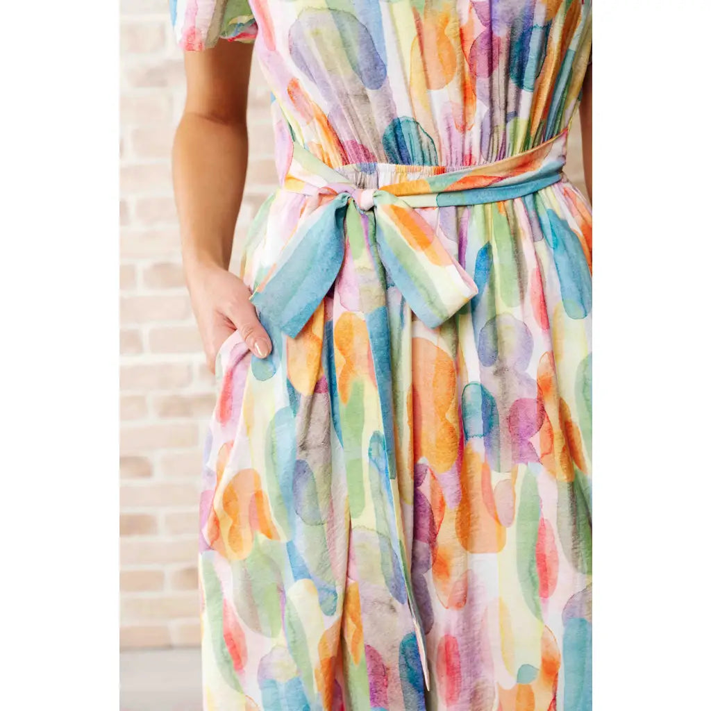 Midi dress with abstract watercolor print sleeves and flattering fit. Available in standard plus size. Spring ready