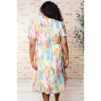 Midi dress with abstract watercolor print sleeves and flattering fit. Available in standard plus size. Spring ready