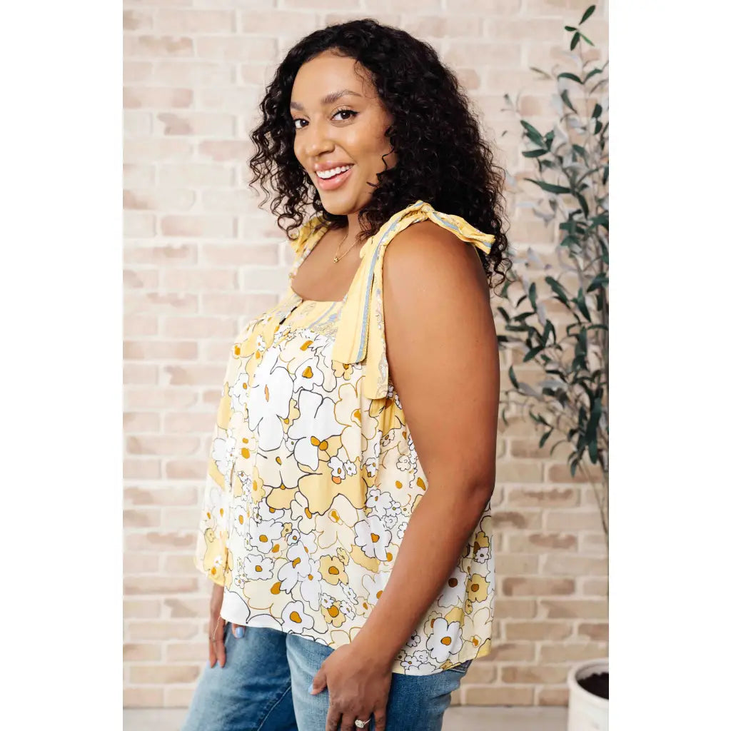 Our What’s Happening Here Yellow Floral Tank is playful and feminine! It features a woven fabric functional shoulder