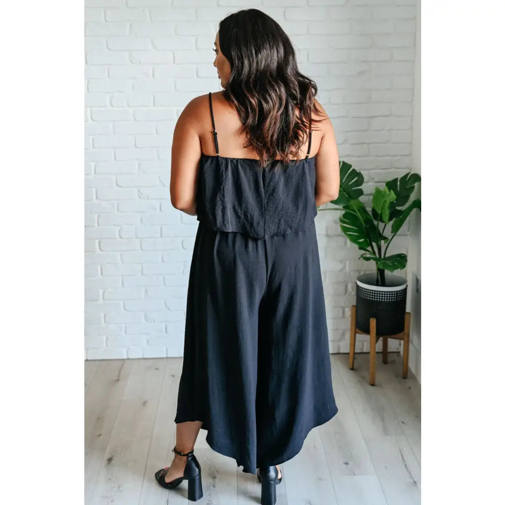 Chic black wide leg jumpsuit with adjustable straps tiered bodice and side pockets. Size inclusive from Small to 3XL