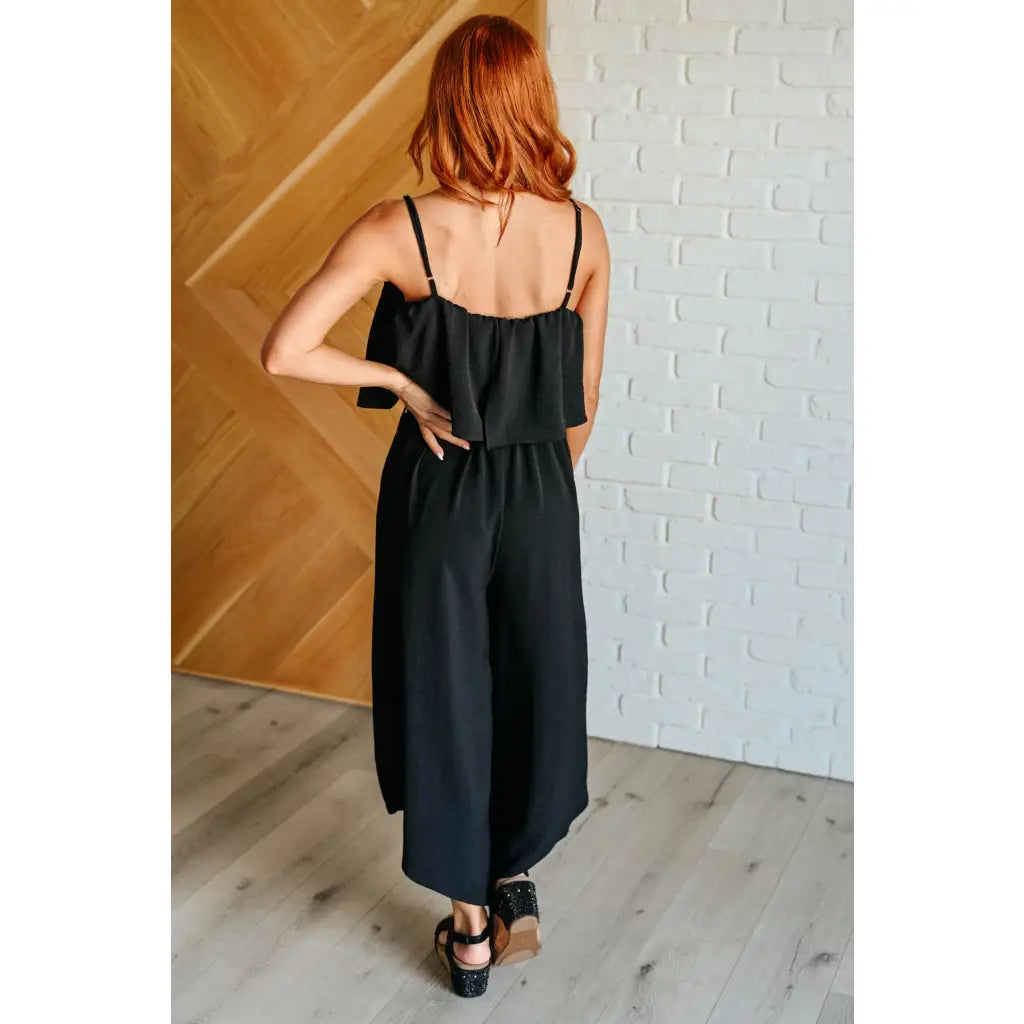 Chic black wide leg jumpsuit with adjustable straps tiered bodice and side pockets. Size inclusive from Small to 3XL
