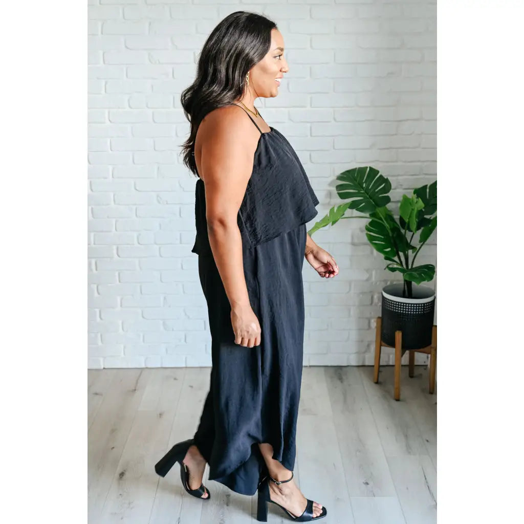 Chic black wide leg jumpsuit with adjustable straps tiered bodice and side pockets. Size inclusive from Small to 3XL