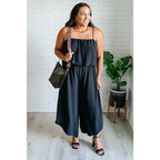 Chic black wide leg jumpsuit with adjustable straps tiered bodice and side pockets. Size inclusive from Small to 3XL
