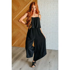 Chic black wide leg jumpsuit with adjustable straps tiered bodice and side pockets. Size inclusive from Small to 3XL
