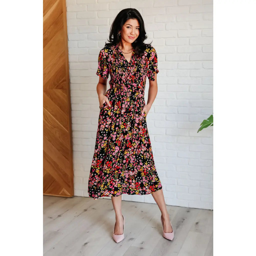 Our Wildflower and Barley V-Neck Button Up Dress is crafted from a stunning black floral printed textured woven fabric.