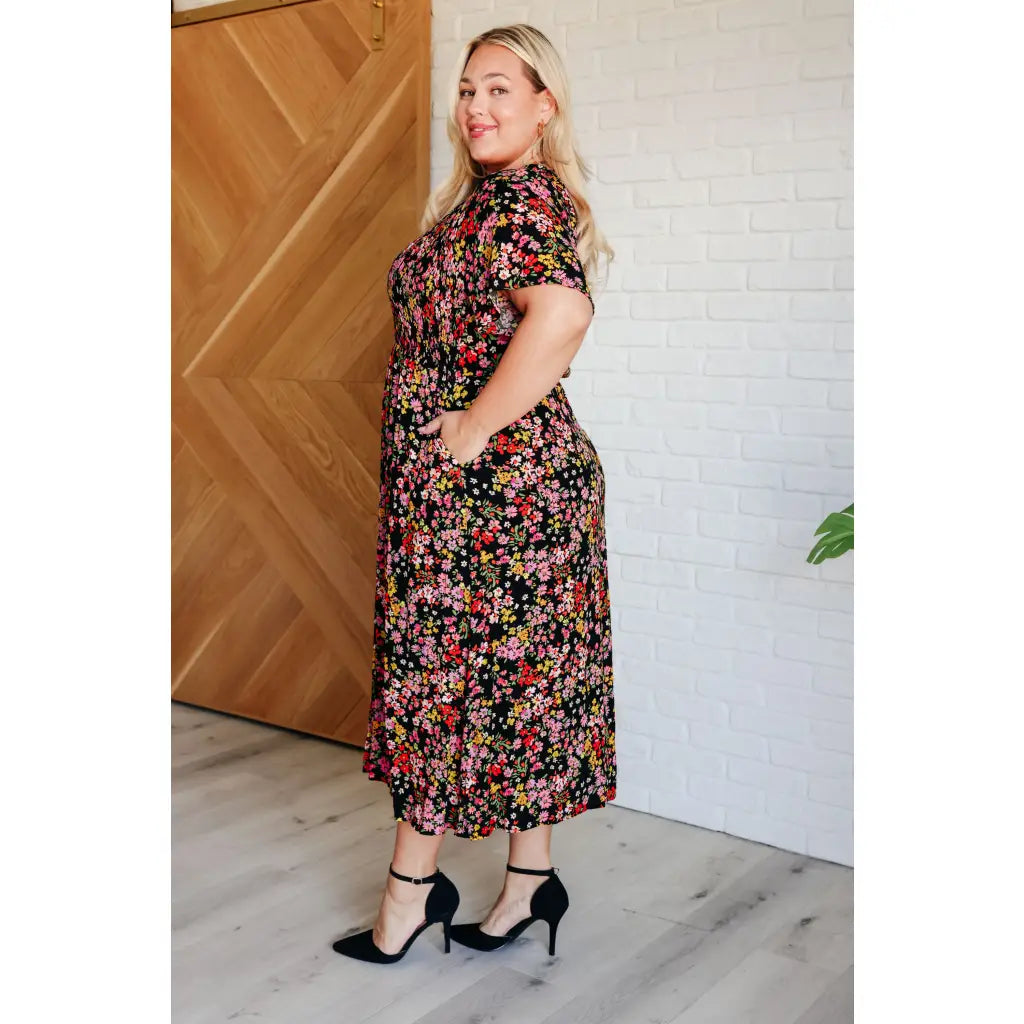 Our Wildflower and Barley V-Neck Button Up Dress is crafted from a stunning black floral printed textured woven fabric.