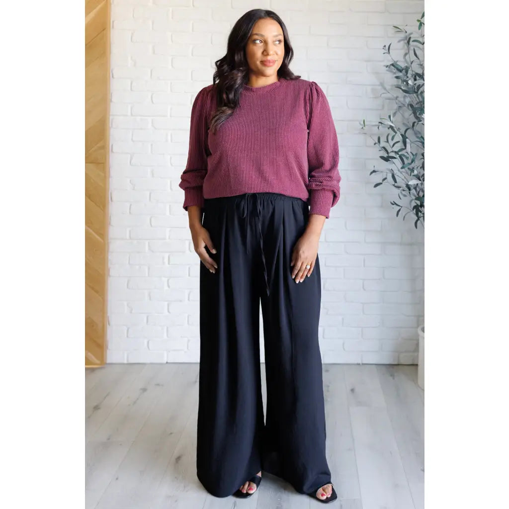 Get cozy in our Wine Down Ribbed Knit Top! The round neckline and gathered shoulder details add a touch of flirty charm