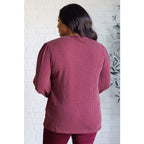 Get cozy in our Wine Down Ribbed Knit Top! The round neckline and gathered shoulder details add a touch of flirty charm