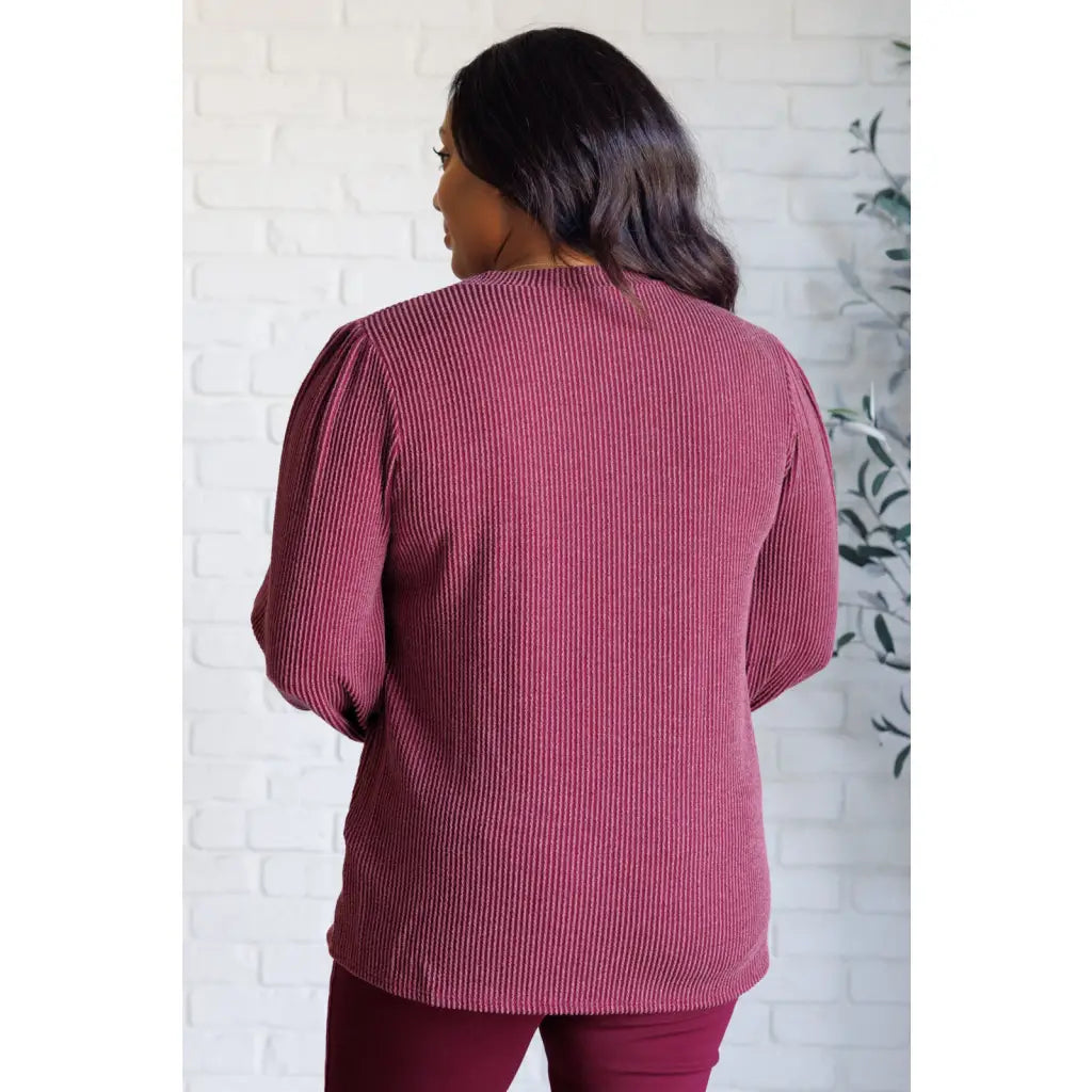 Get cozy in our Wine Down Ribbed Knit Top! The round neckline and gathered shoulder details add a touch of flirty charm