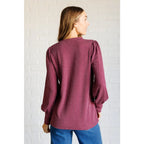 Get cozy in our Wine Down Ribbed Knit Top! The round neckline and gathered shoulder details add a touch of flirty charm