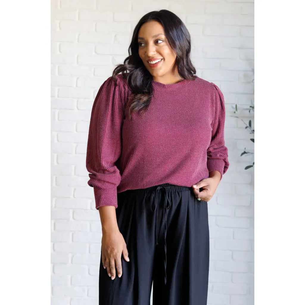Get cozy in our Wine Down Ribbed Knit Top! The round neckline and gathered shoulder details add a touch of flirty charm