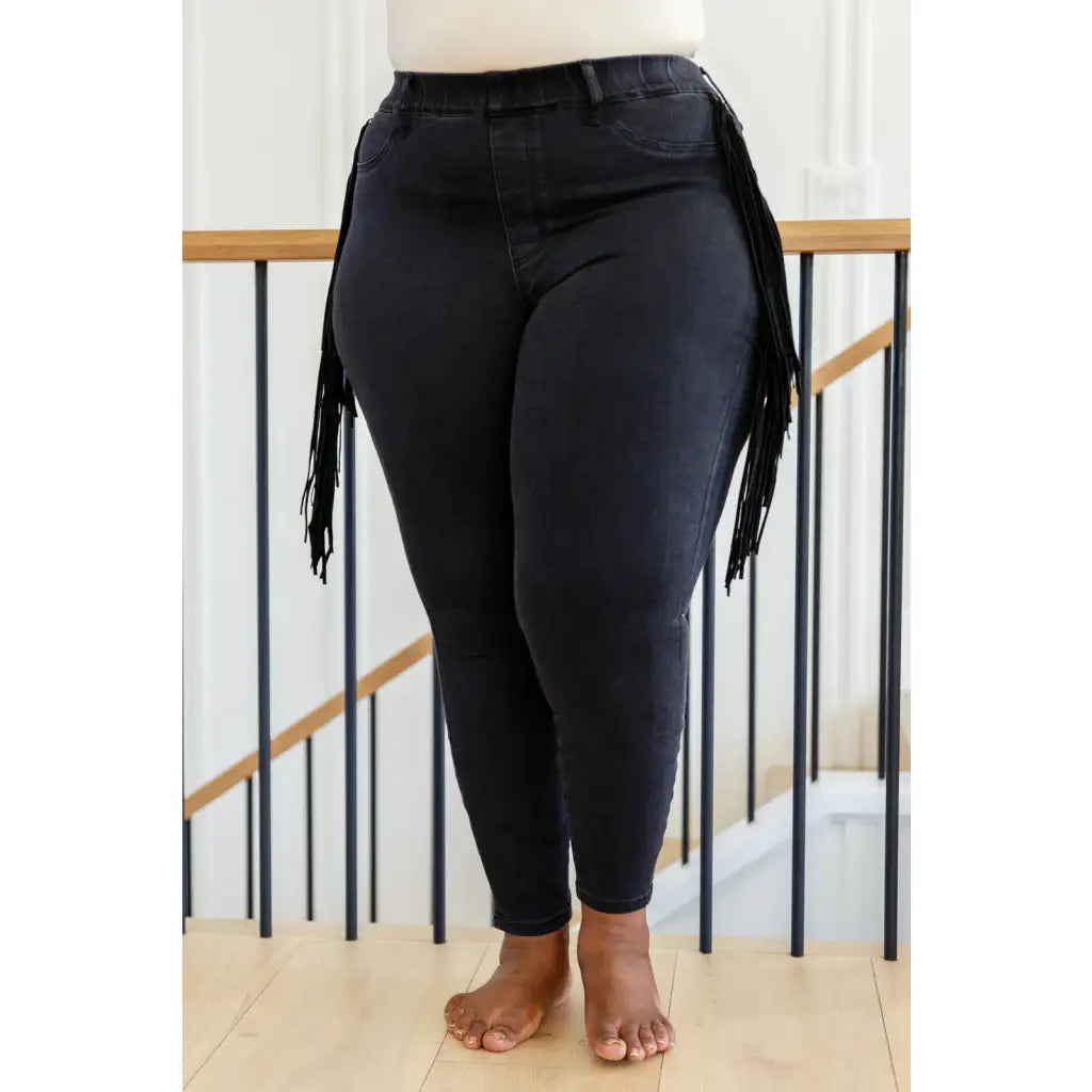 Rock the look in our Hilary Side Fringe Black Skinny Jeggings by Judy Blue! These stretchy denim jeggings feature a mid