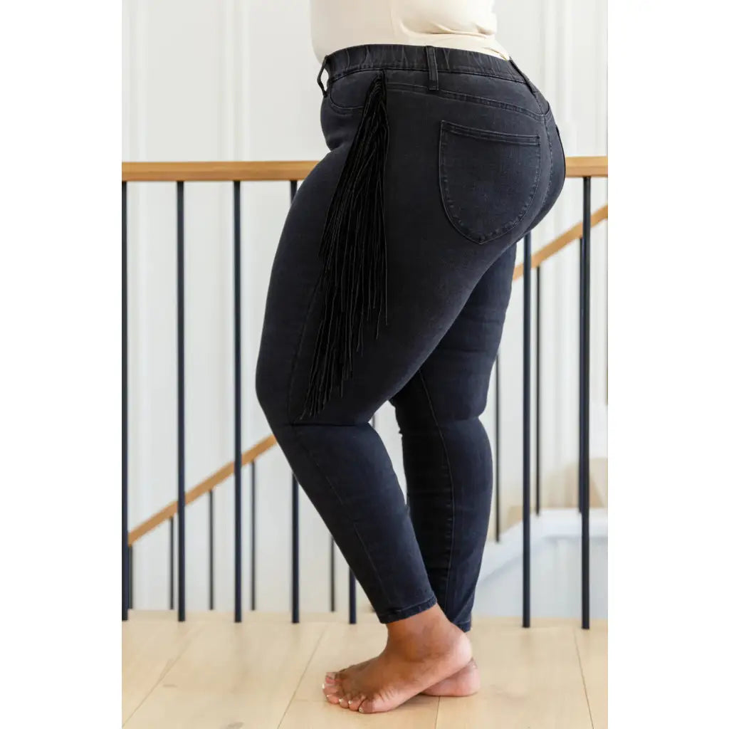 Rock the look in our Hilary Side Fringe Black Skinny Jeggings by Judy Blue! These stretchy denim jeggings feature a mid