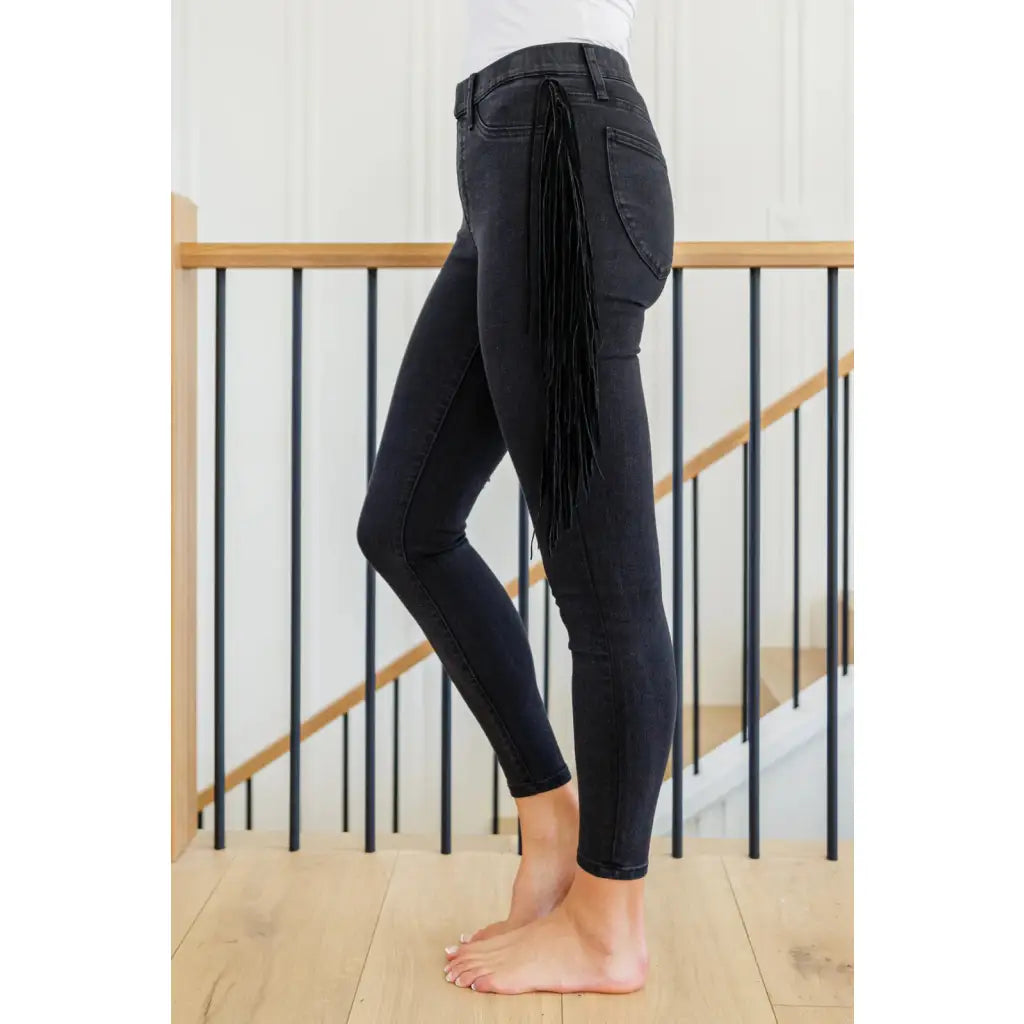 Rock the look in our Hilary Side Fringe Black Skinny Jeggings by Judy Blue! These stretchy denim jeggings feature a mid
