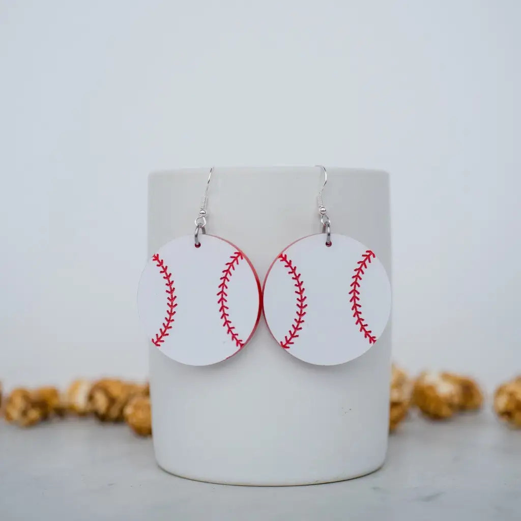 Red and white baseball acrylic dangle earrings. 1.5 inch length. Great for sensitive ears! Material: Specialty