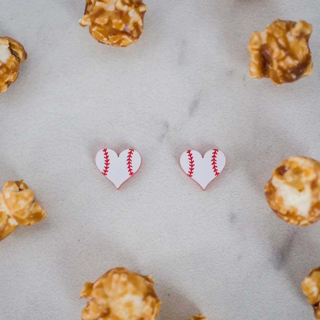 Hand drawn laser cut and engraved red & white baseball heart acrylic studs. Great for sensitive ears! 13mm x 14mm