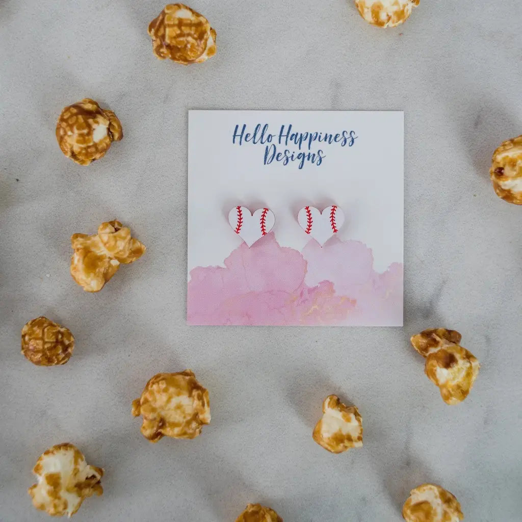 Hand drawn laser cut and engraved red & white baseball heart acrylic studs. Great for sensitive ears! 13mm x 14mm